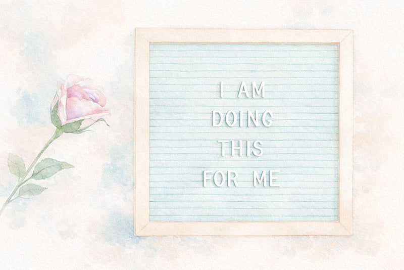 Framed letter board with the message ‘I AM DOING THIS FOR ME’ next to a pink rose.